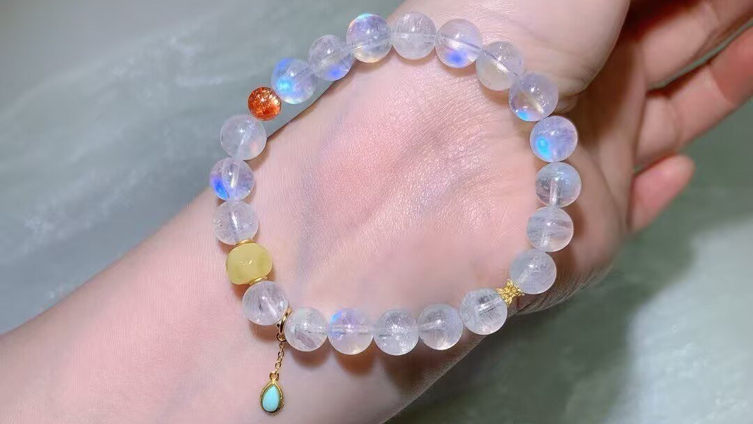 Natural blue moonstone bracelet with a soft blue flash worn on a wrist