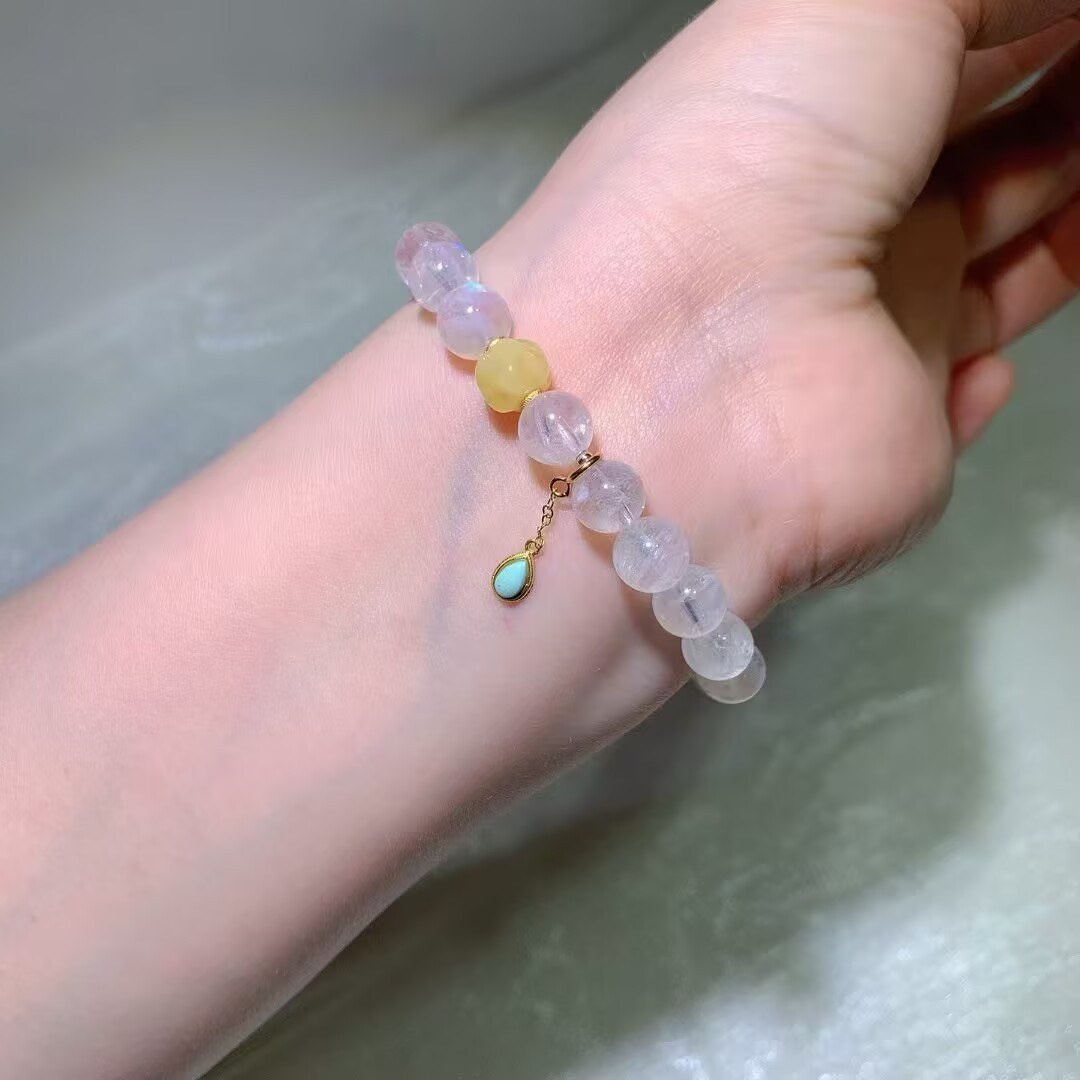 Natural blue moonstone bracelet with a soft blue flash on a wrist