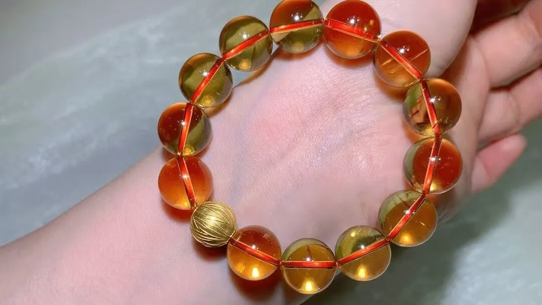 Natural Brazilian citrine bracelet with large clear golden-to-orange beads on a wrist