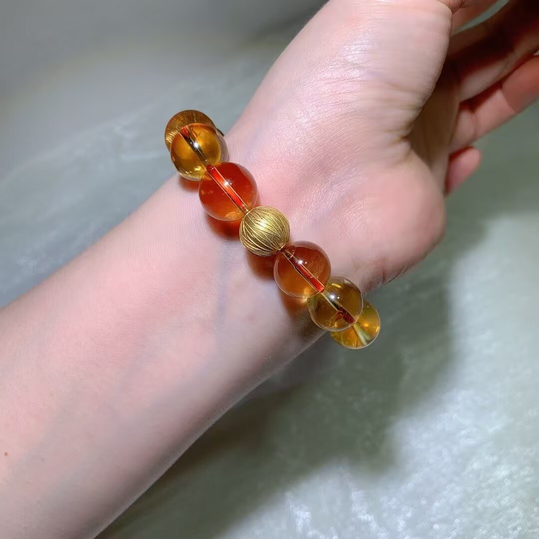 Natural Brazilian citrine bracelet with large clear golden-to-orange beads on a red cord