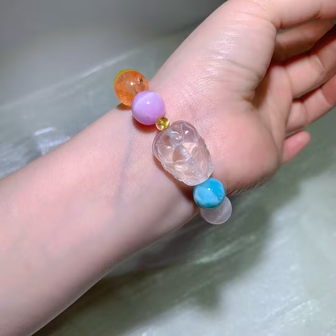 13mm natural multi-gem bracelet with a carved clear focal bead