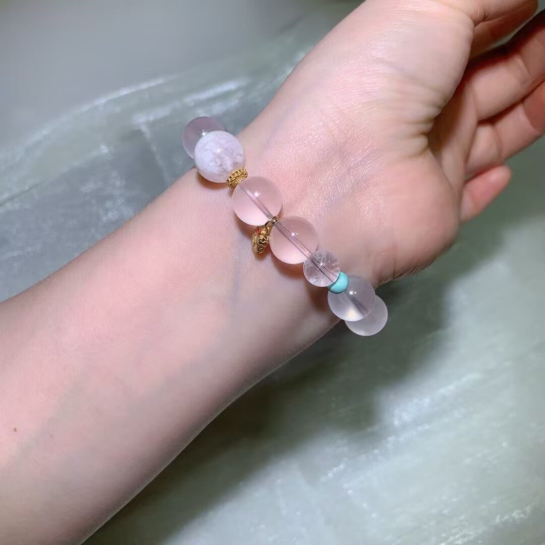 Detail of Star Rose Quartz beads with a soft, gently translucent pink glow