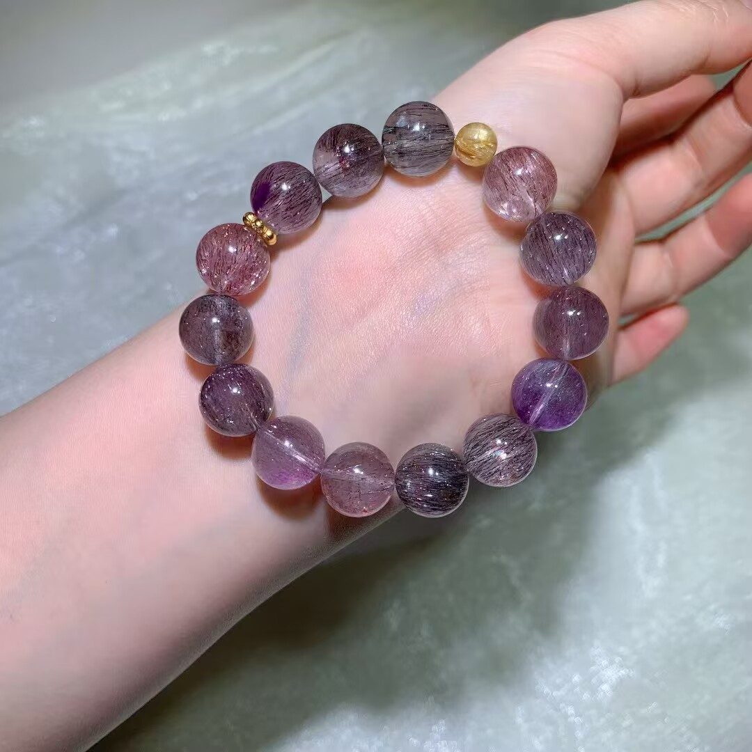 Natural Super Seven Crystal Bracelet worn on the wrist in daylight