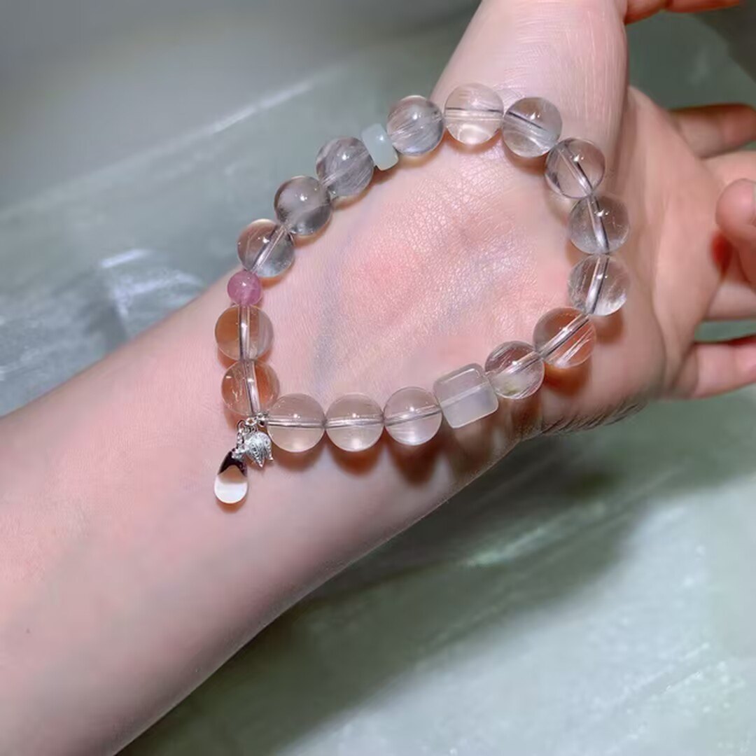 White rabbit hair quartz bracelet glowing like frost in daylight